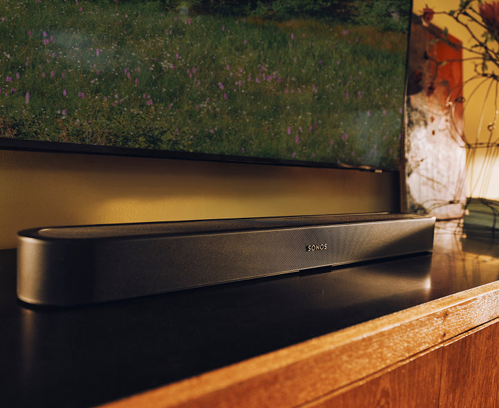 The soundbar in place under a wall-mounted TV